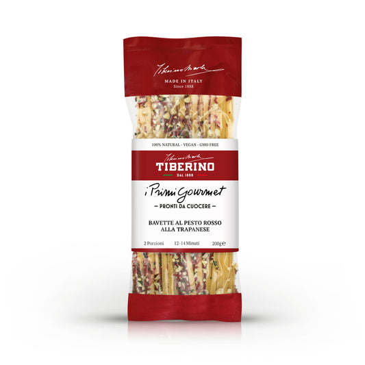 Confezione trasparente e rossa di Bavette al Pesto Rosso alla Trapanese Tiberino 1888, 200g, con pasta e condimento visibili.
