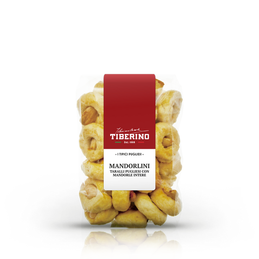 Confezione trasparente di Mandorlini Tiberino 1888, taralli pugliesi dorati con mandorle intere, etichetta rossa.