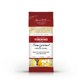 Confezione rossa e trasparente di Risotto con Zafferano alla Milanese Tiberino 1888, 200g, con riso visibile.