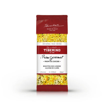 Confezione rossa di Risotto con Limone all'uso di Capri Tiberino 1888, 200g, con riso giallo e spezie visibili.