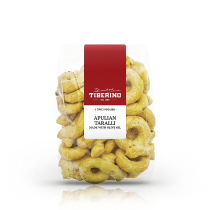 Confezione trasparente di Taralli Pugliesi Tiberino 1888, anelli dorati con etichetta rossa e bianca.