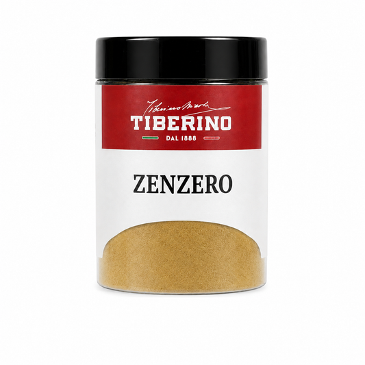 Barattolo trasparente con coperchio nero e etichetta rossa Tiberino 1888, contenente zenzero in polvere beige chiaro.