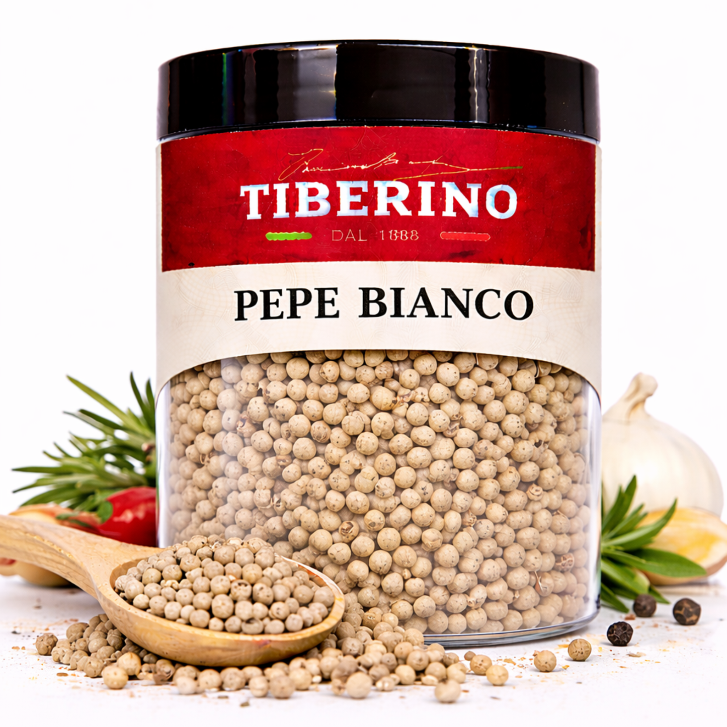 Barattolo trasparente di Pepe Bianco Tiberino 1888 da 50 g con coperchio nero, cucchiaio di legno e ingredienti.